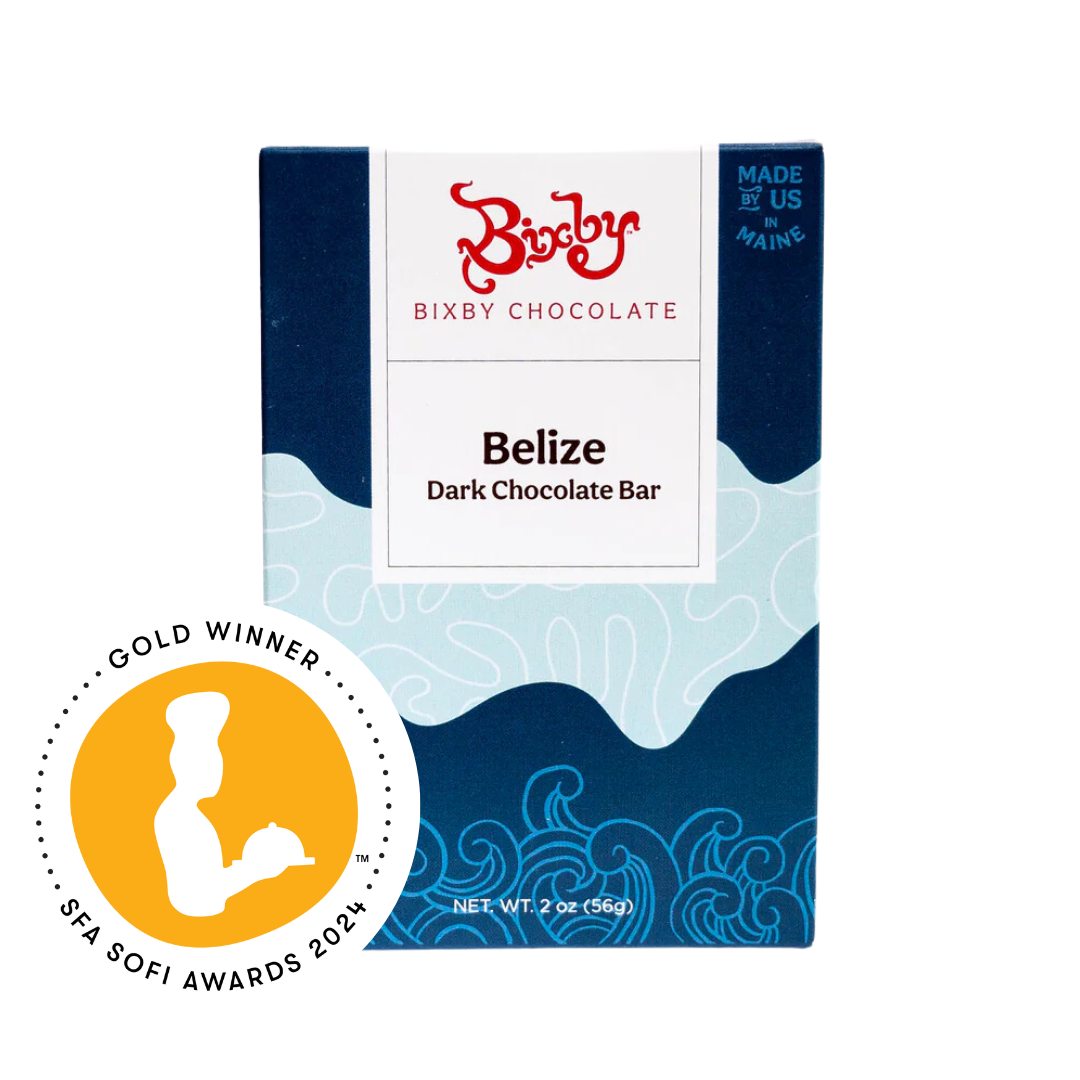 A blue box of Bixby Chocolate Belize Dark Chocolate Bar with ocean wave patterns, and a gold “SFA Sofi Awards 2021 Gold Winner” badge on the left side.