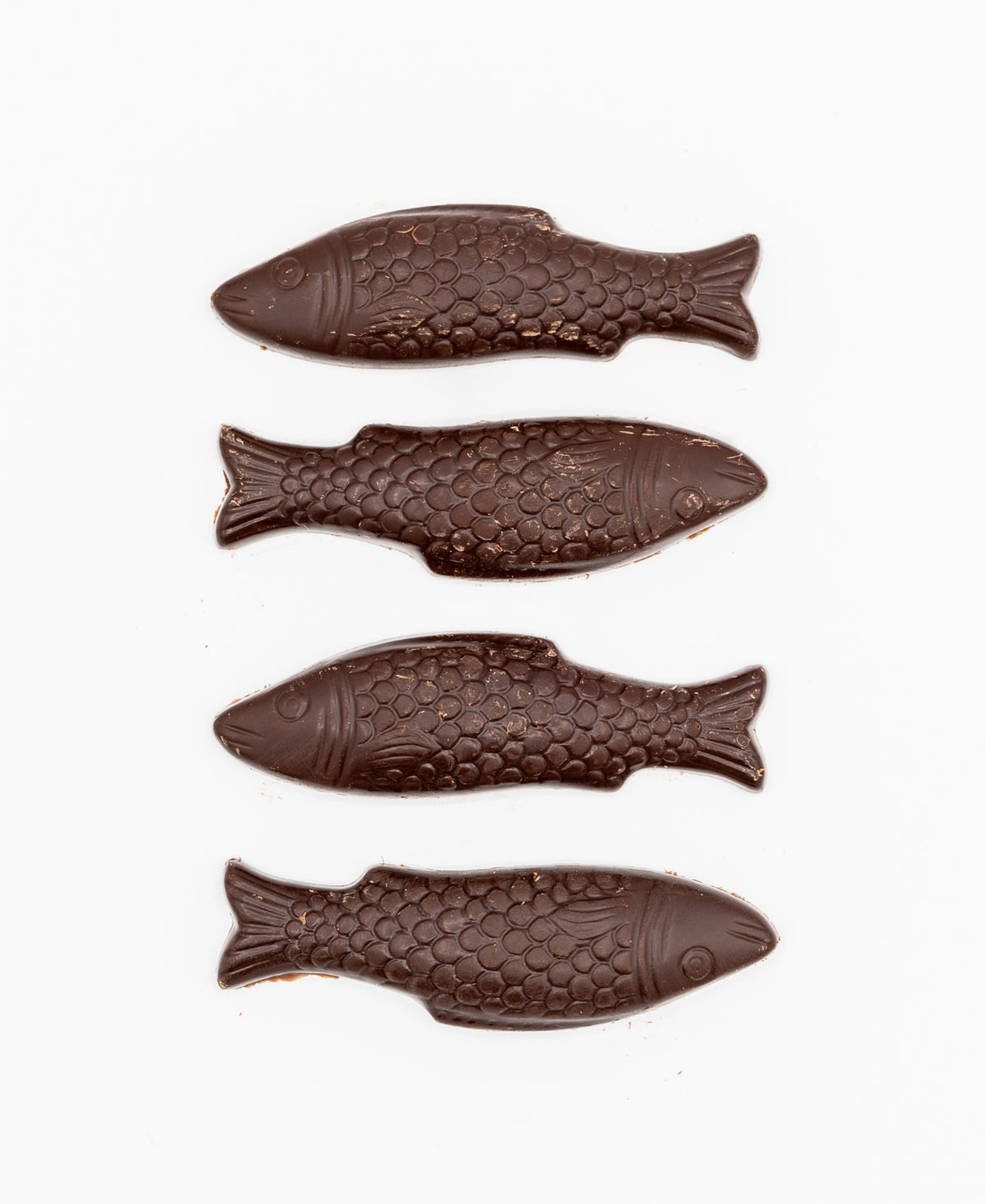 Four Bixby Chocolates Chocolate Sardines, tinned and crafted with detailed scales and fins, are arranged vertically on a white background—a delightful Maine souvenir for chocolate lovers.