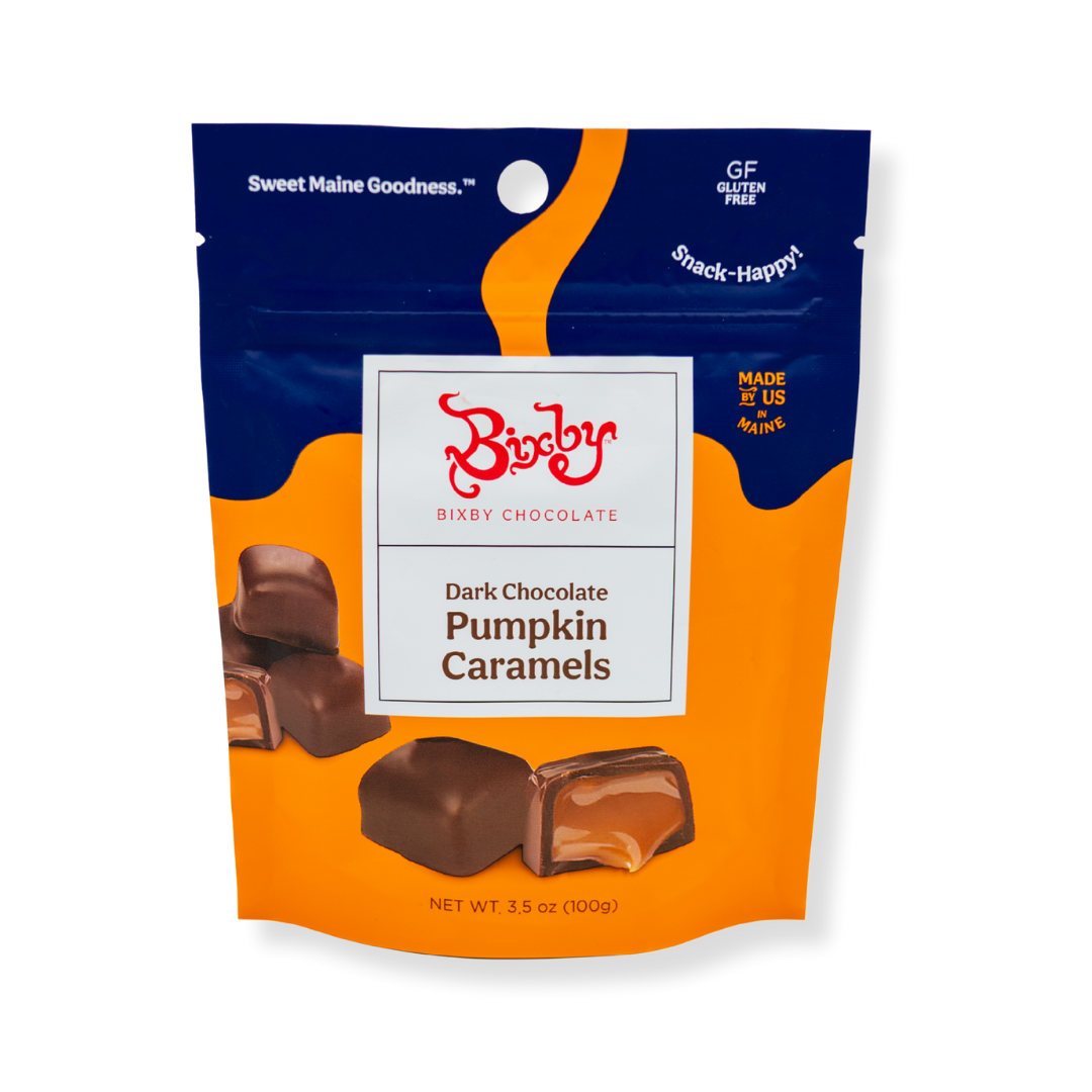 A 6-pouch set of Bixby Chocolates Pumpkin Caramels, featuring blue and orange packaging with images of pumpkin caramel-filled pieces on the front; net weight is 3.5 oz (100g) per pouch.