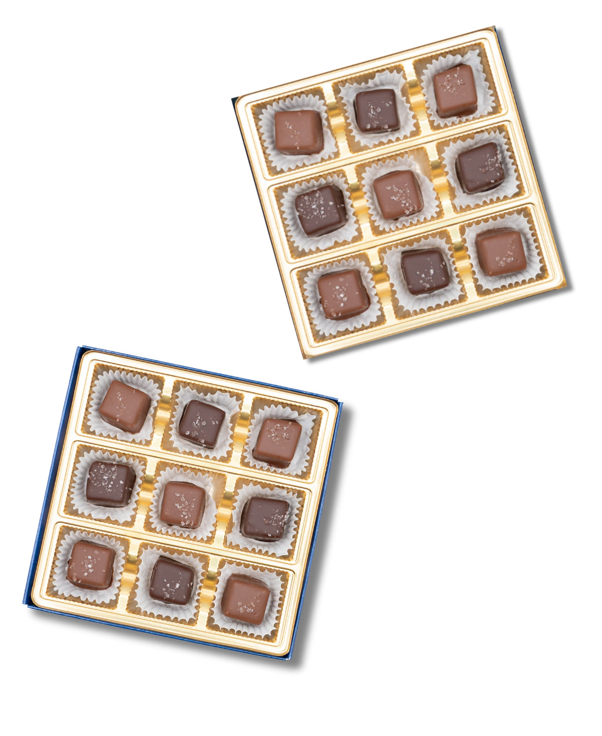 Two gold trays from Bixby Chocolates’ Chocolate Sea Salted Caramels Gift Box, each with 12 assorted square chocolates arranged in a 3x4 grid in paper wrappers, are displayed on a white background.