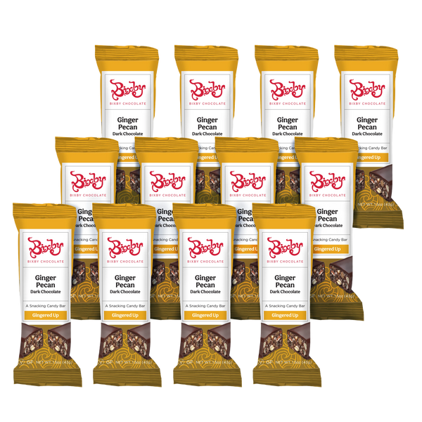 Twelve bars of Bixby Chocolates' Gingered Up® - Dark Chocolate + Crystalized Ginger & Pecan (Vegan) are arranged in rows, with yellow and brown packaging showing chocolate pieces, pecans, ginger, and the product name.