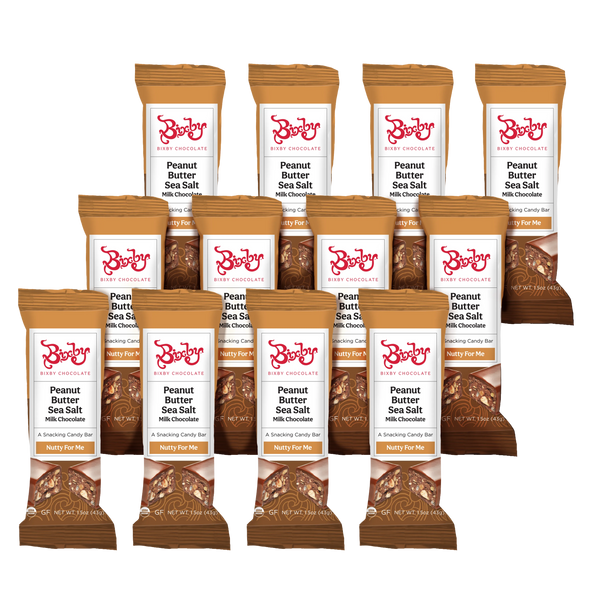 Twelve Nutty for Me bars by Bixby Chocolates are arranged in rows. The brown packaging reads “Milk Chocolate + Crunchy Peanut Butter + Maine Sea Salt” and features images of chocolate and peanuts.
