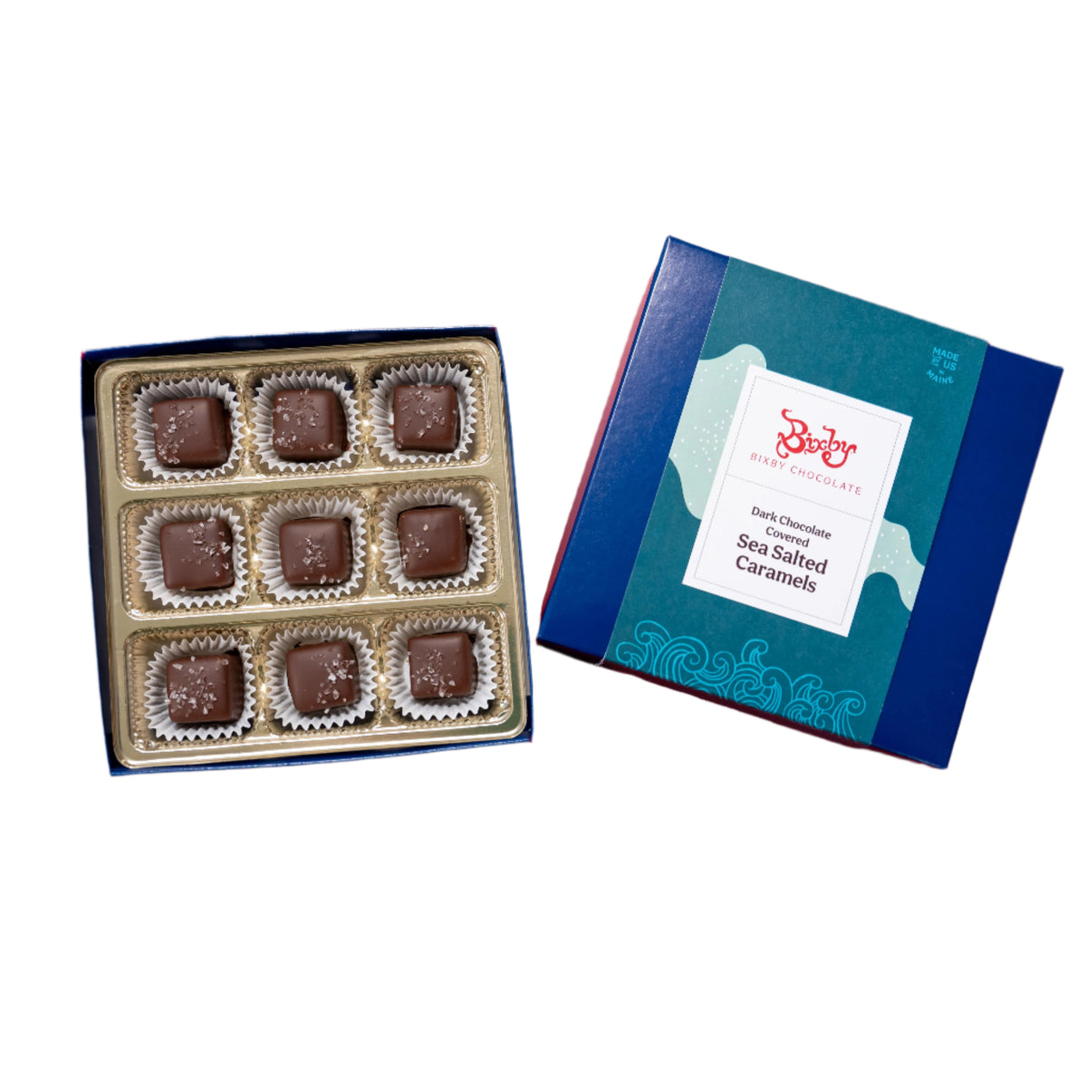 An open Bixby Chocolates Dark Chocolate Sea Salted Caramels Gift Box reveals nine artisanal caramels, with the lid set beside it to display the product label.