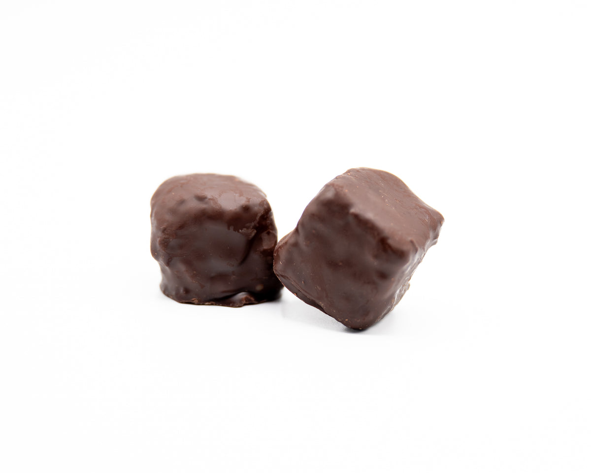 Two small, square Bixby Chocolates Needhams—a classic Maine treat—are placed close together on a white background.
