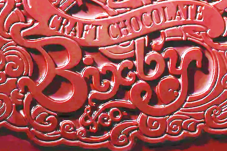 Close up of a Bixby chocolate bar with the words BIXBY carved into the front.