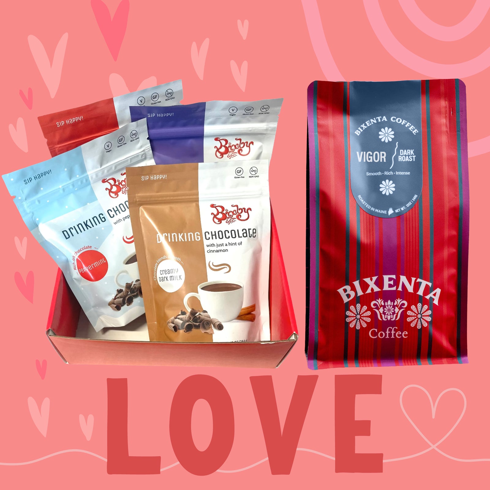 A box with four packets of Booby Drinking Chocolate in different flavors sits next to a red-striped bag of Bixenta Coffee, all against a pink background with heart designs and the word LOVE written at the bottom.