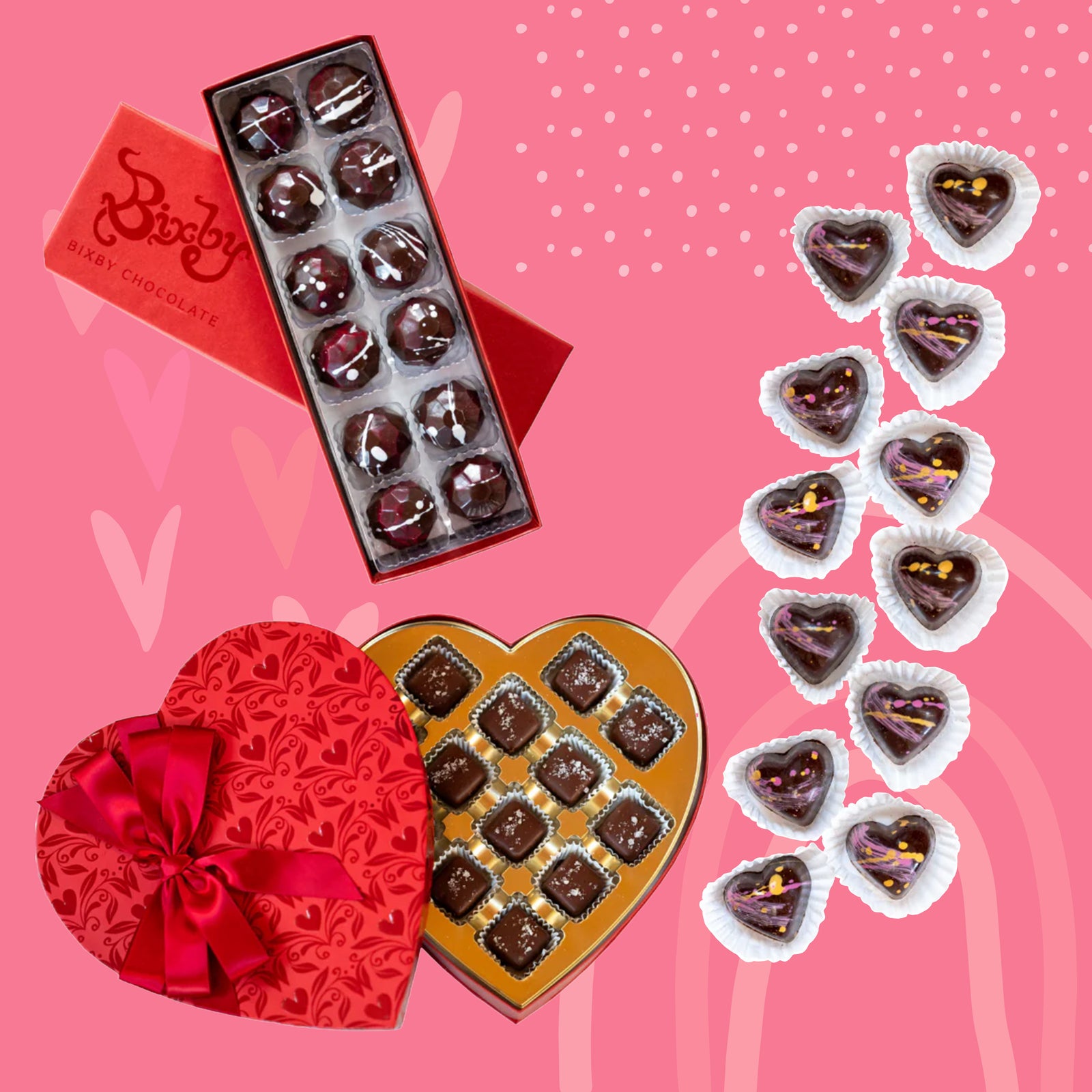 Assorted heart-shaped and round chocolates in red and gold gift boxes, with some individual chocolates arranged on a pink background decorated with hearts and patterns.
