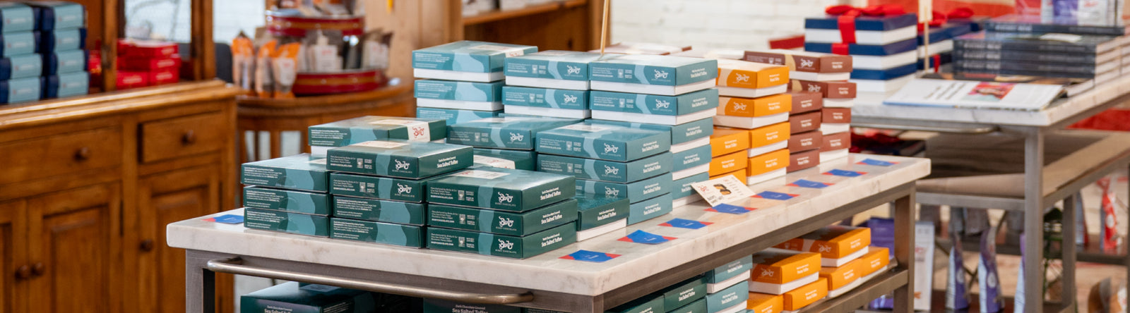 An image of Bixby warehouse with boxes of chocolates on shelves and workers grabbing them.