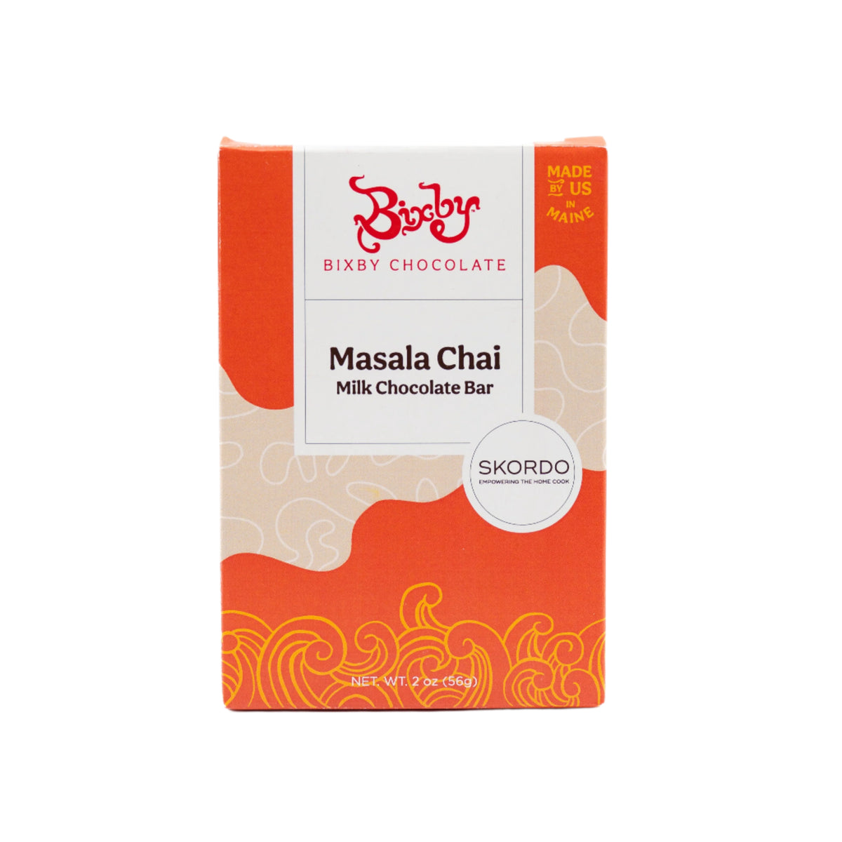 The Skordo Chai Milk Chocolate Bar by Bixby Chocolates features orange, beige, and white swirled packaging, highlights a Maine family-owned collaboration, is labeled "Made in Maine, USA," and has a net weight of 2 oz (56g).