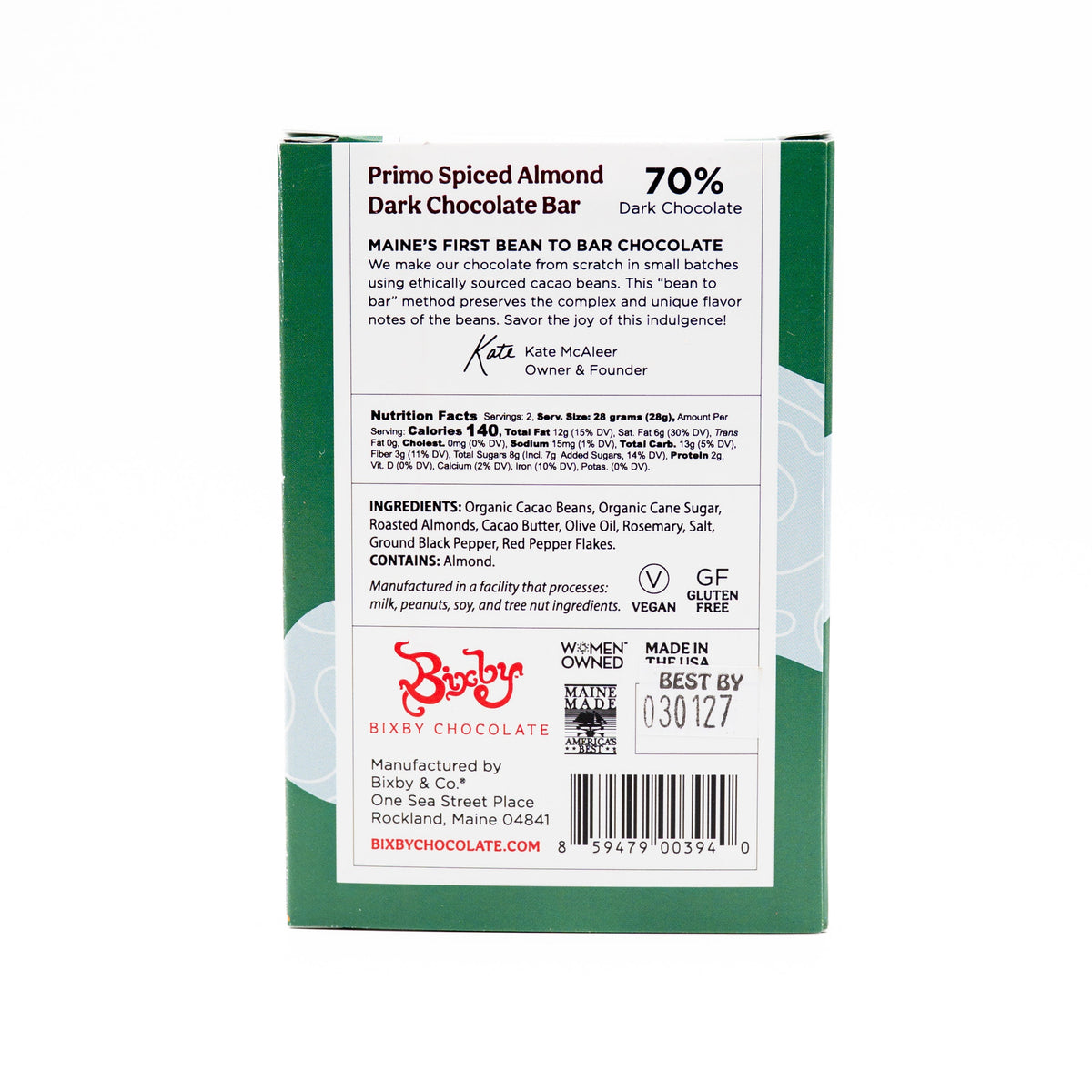 Back of a Bixby Chocolates Primo Dark Chocolate Spiced Olive Oil Roasted Almond Bar showing product info, ingredients, nutrition facts, founder’s note, certification icons, and a green and white design with Dominican organic cocoa beans and Best By date.