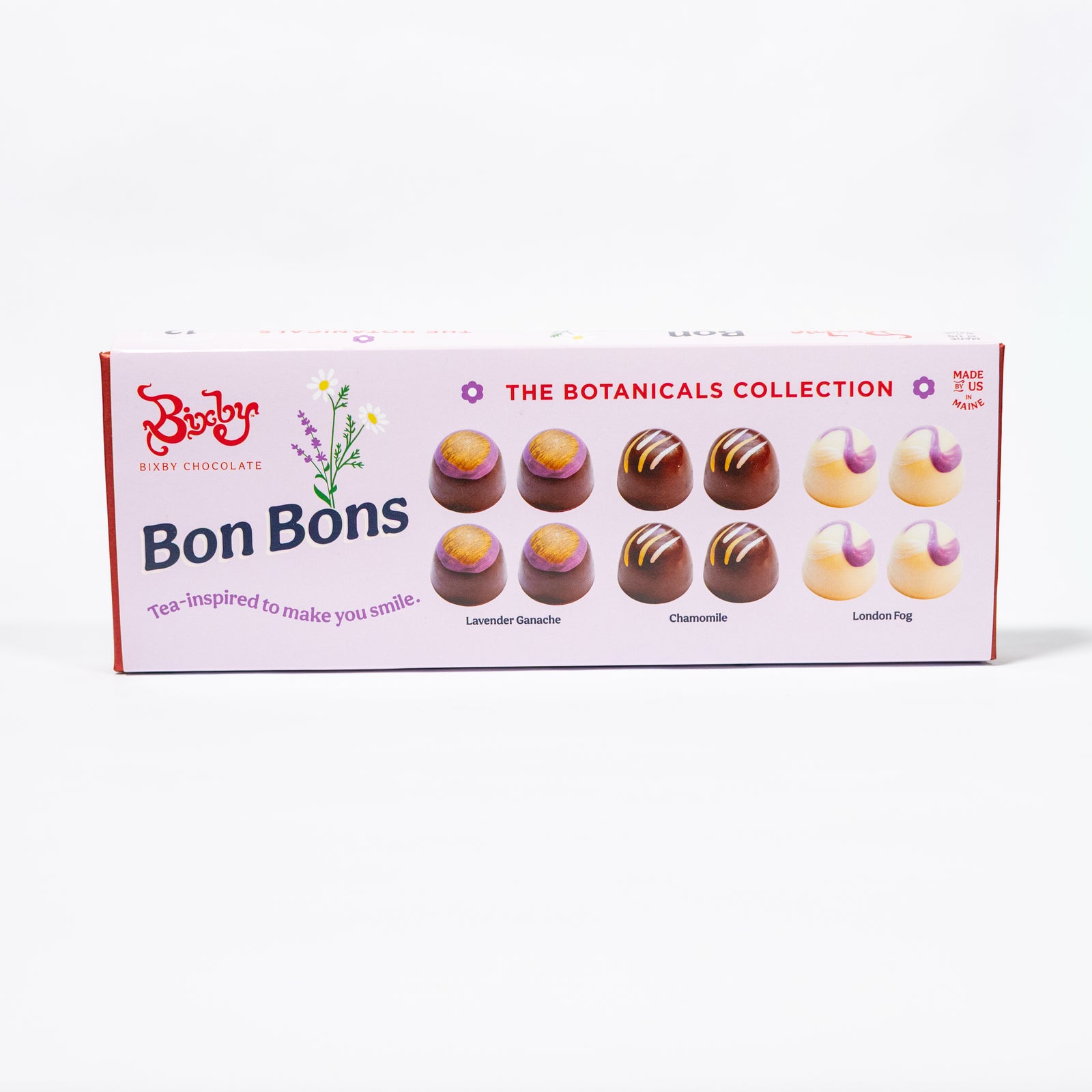 A rectangular box of Biscuit Bon Bons from The Botanicals Collection, featuring illustrations of chocolate bonbons in lavender, chamomile, and lemon flavors on a clean white background.