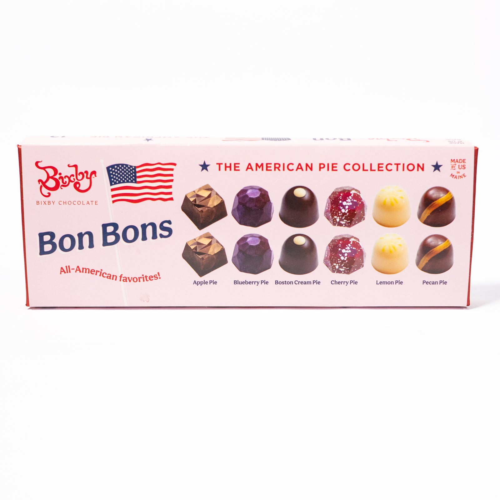 A box of Boston Cream Chocolate Bonbons from 'The American Pie Collection' on a clean white background. The pink box features illustrations of various chocolate bonbons and lists flavors like Apple Pie, Blueberry Pie, Boston Cream Pie, Cherry Pie, Lemon Pie, and Pecan Pie.
