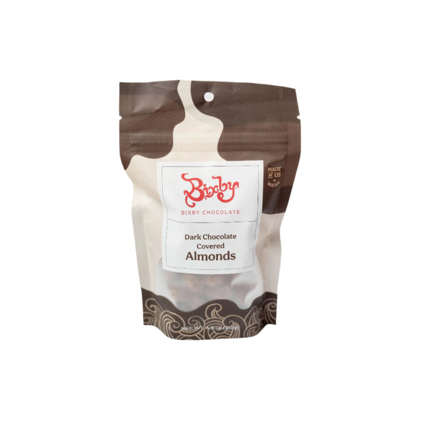A stand-up pouch of Bixby Chocolates Dark Chocolate Almonds with a brown and white design, red Bixby logo, and product name on the front—a healthy snack made with roasted almonds.