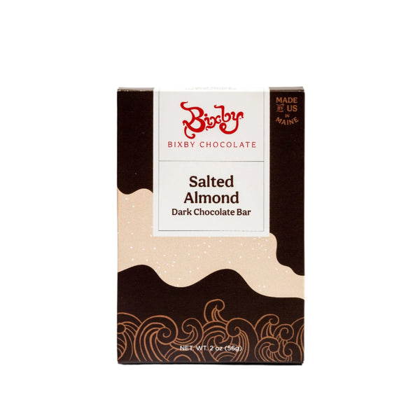 The Bixby Chocolates Dark Chocolate Salted Almond Chocolate Bar features 70% dark chocolate and salted almonds, comes in a beige and brown box with wave designs, is bean to bar and crafted in Maine, USA. Net weight: 2 oz (56g).