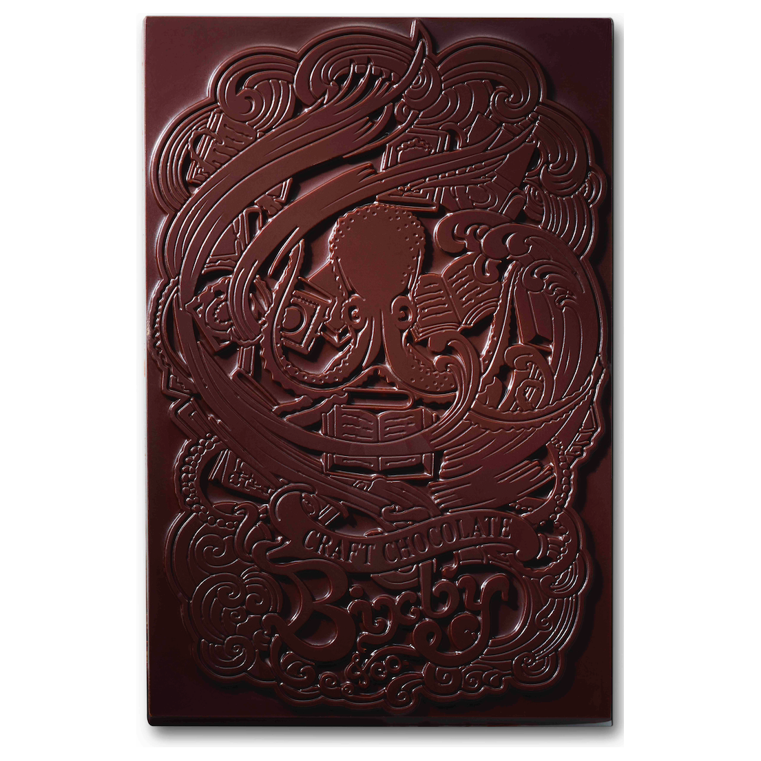 The Organic Haitian 70% Dark Chocolate Bar by Bixby Chocolates features an embossed octopus with books and tools amid swirling patterns, plus “CRAFT CHOCOLATE” and “Bixby Chocolates” at the bottom.